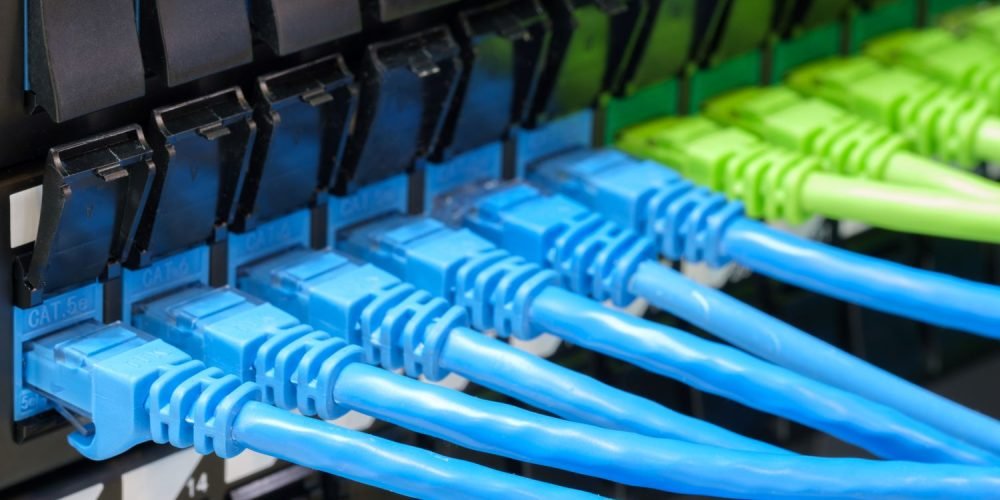 cabos azuis e verdes conectados em uma rede de dados